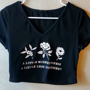 "A little more kindness. A little less judgment" graphic tee.